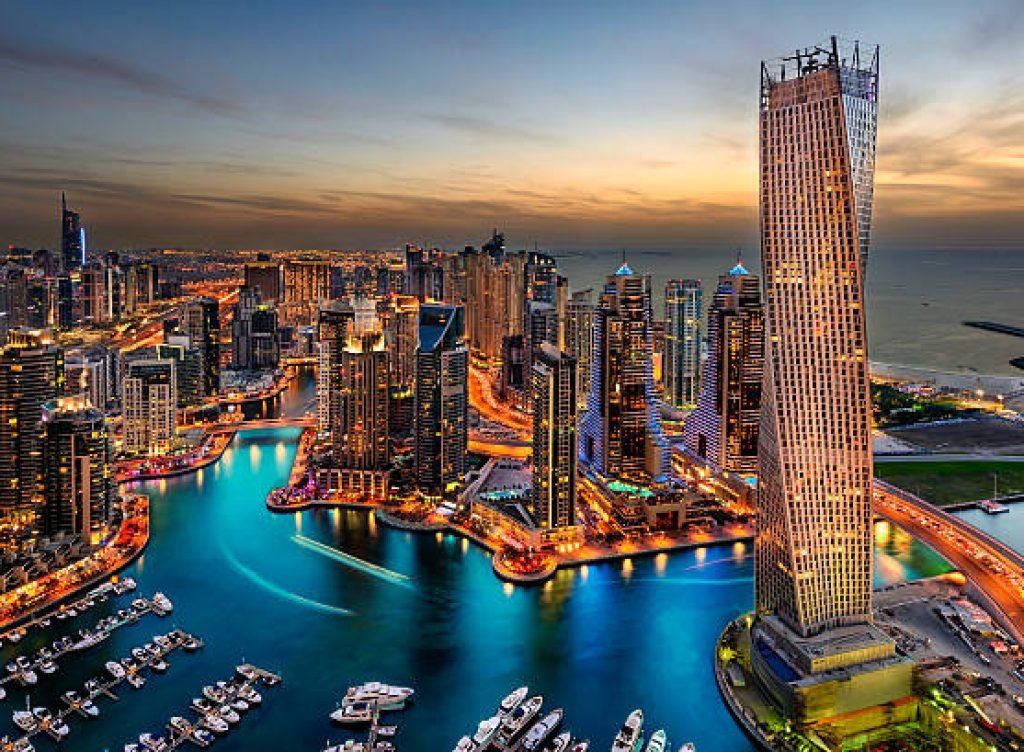 Dubai Marina from a high view showing the boats, sea, and the city scape.